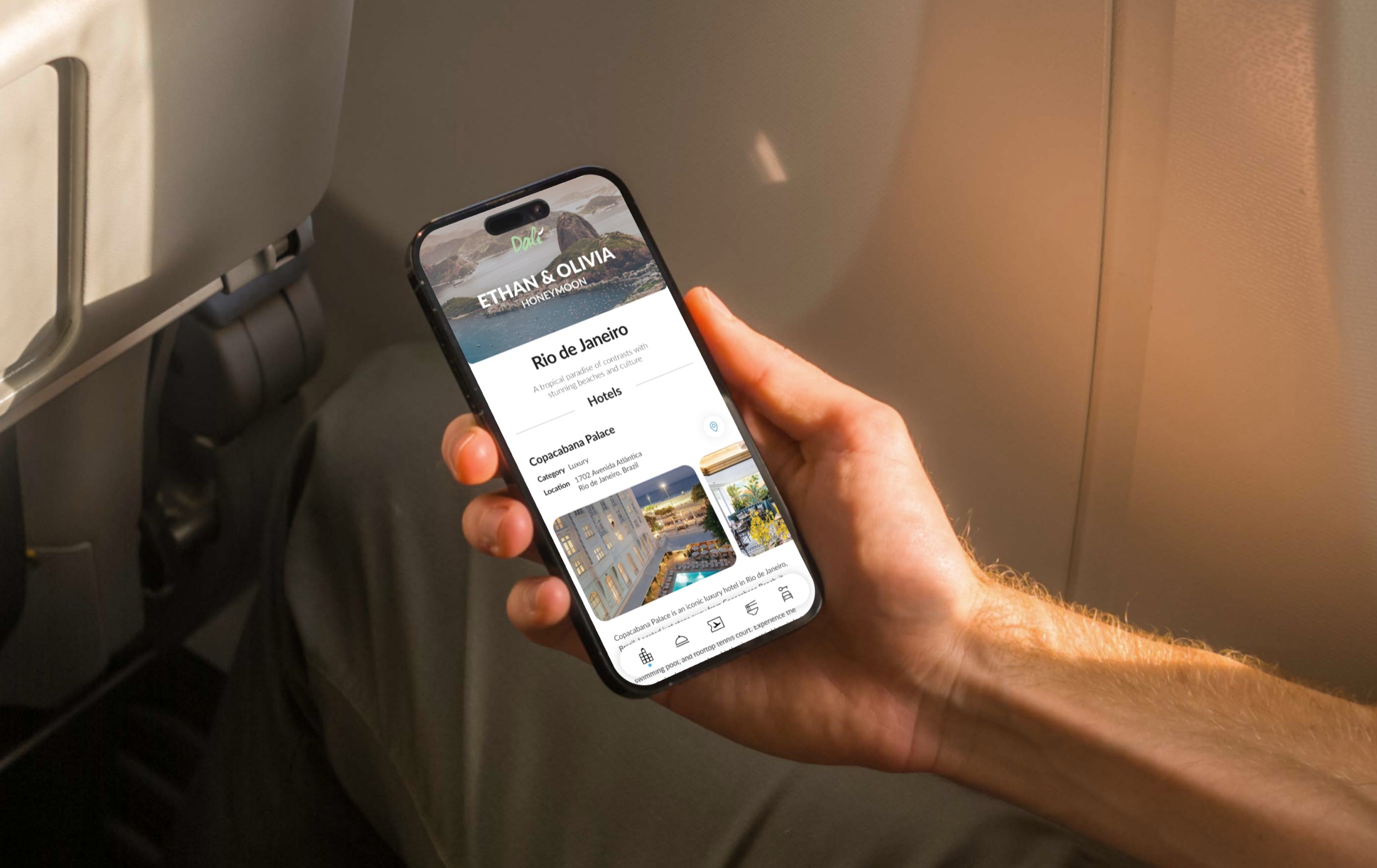 Hand holding an iPhone with a Dali trip proposal open, on board a plane